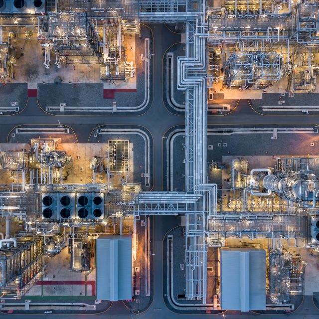 Aerial view power plant for oil refinery petrochemical industrial, Oil  refinery factory power plant at night and pipeline steel, Oil refinery factory and power plant.