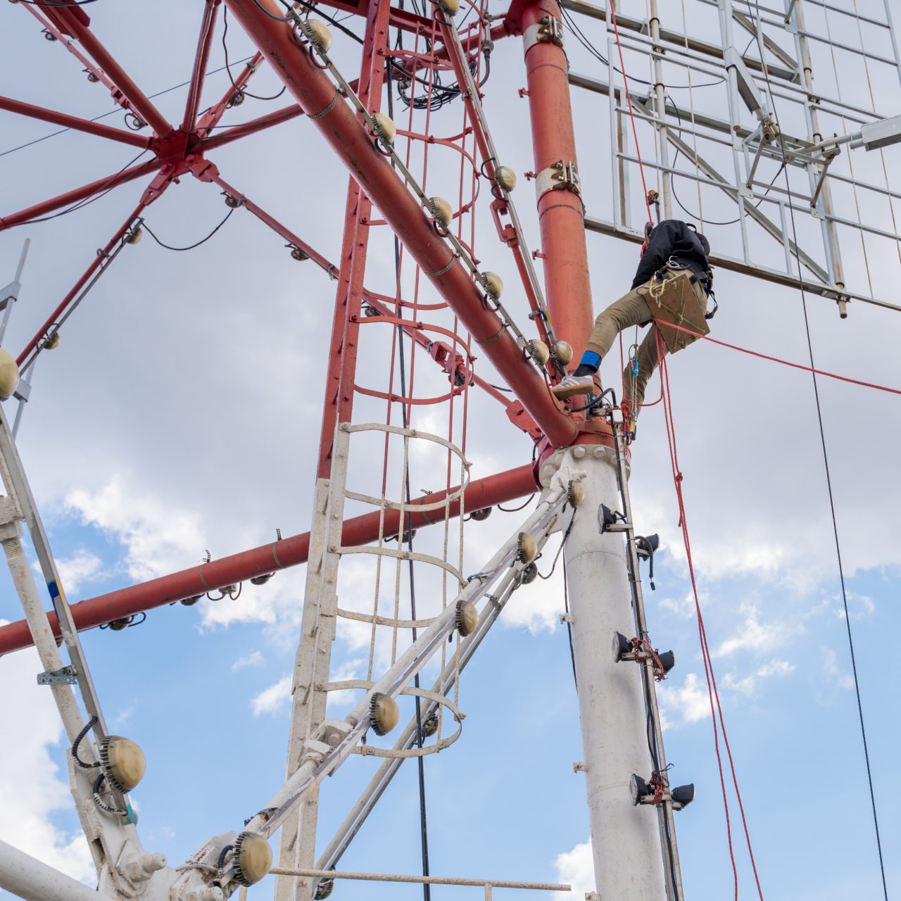 a-worker-with-climbing-equipment-serves-a-city-tv-2025-03-09-18-32-56-utc