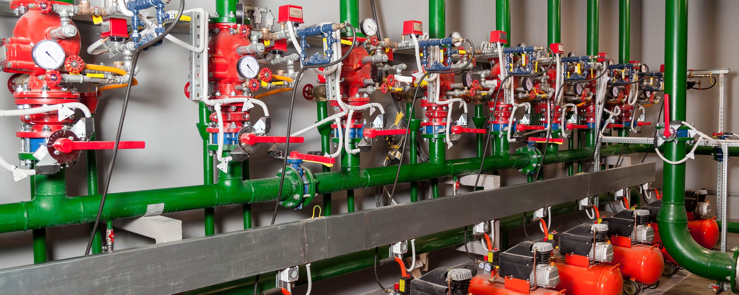 Industrial piping and valve control assemblies inside a building