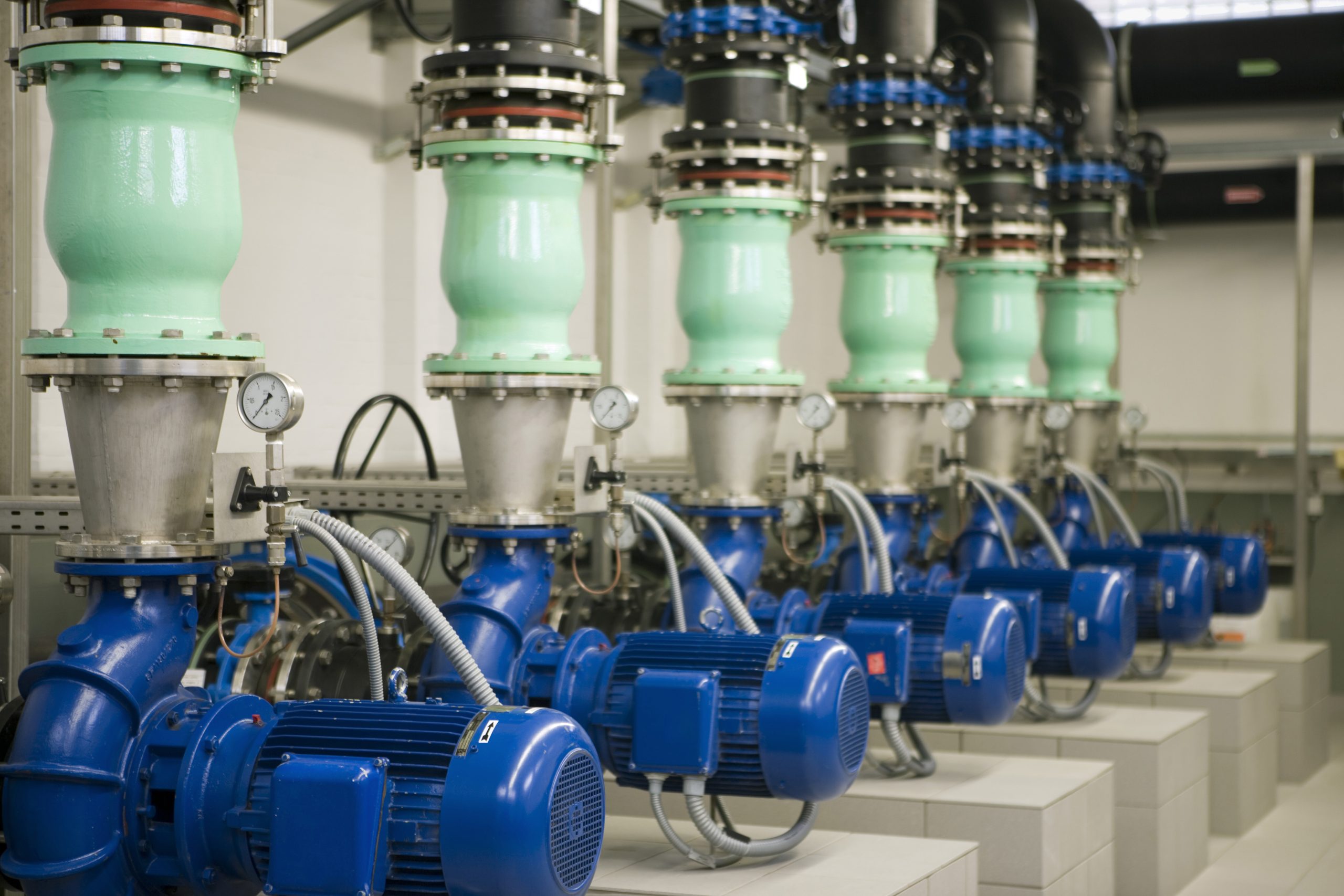 Industrial blue pumps and motors connected to pipework