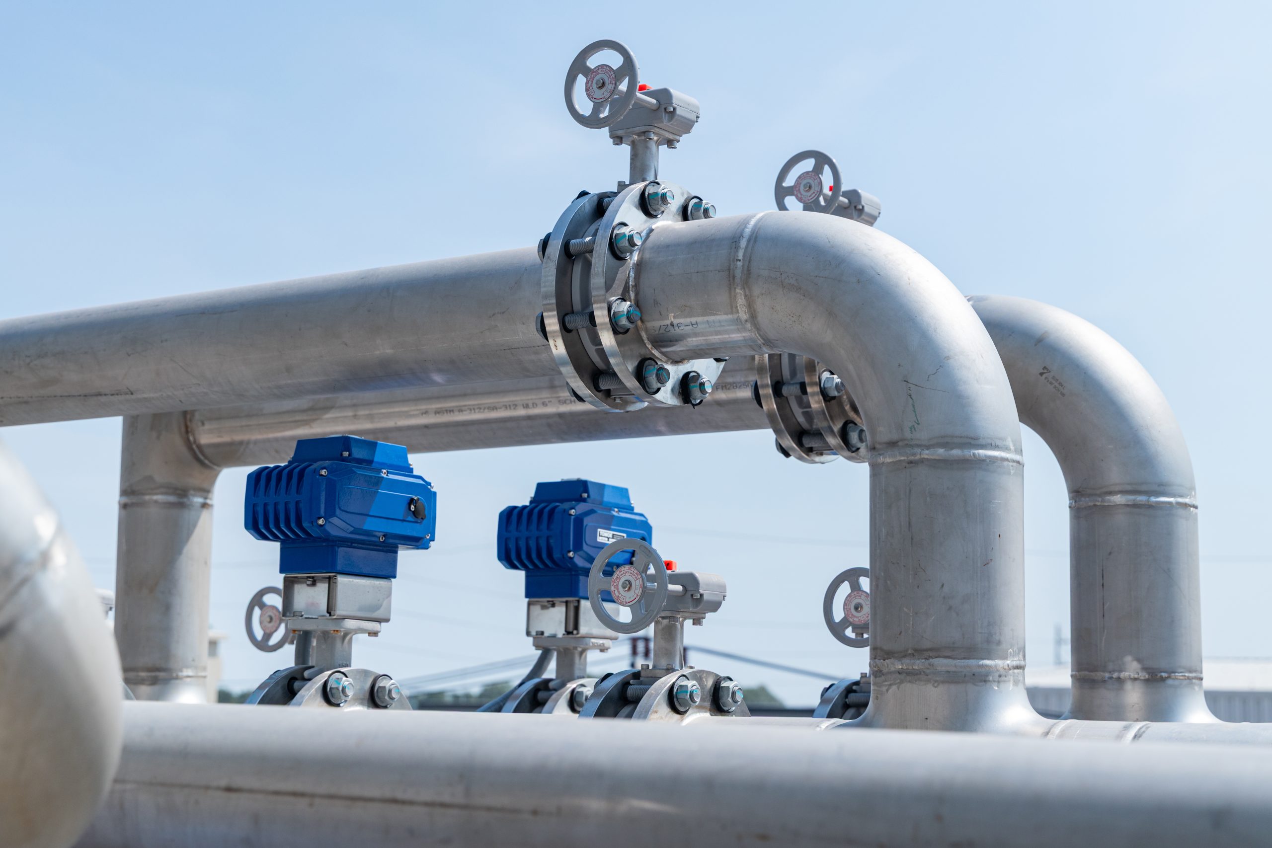Silver steel pipes with blue valve actuators