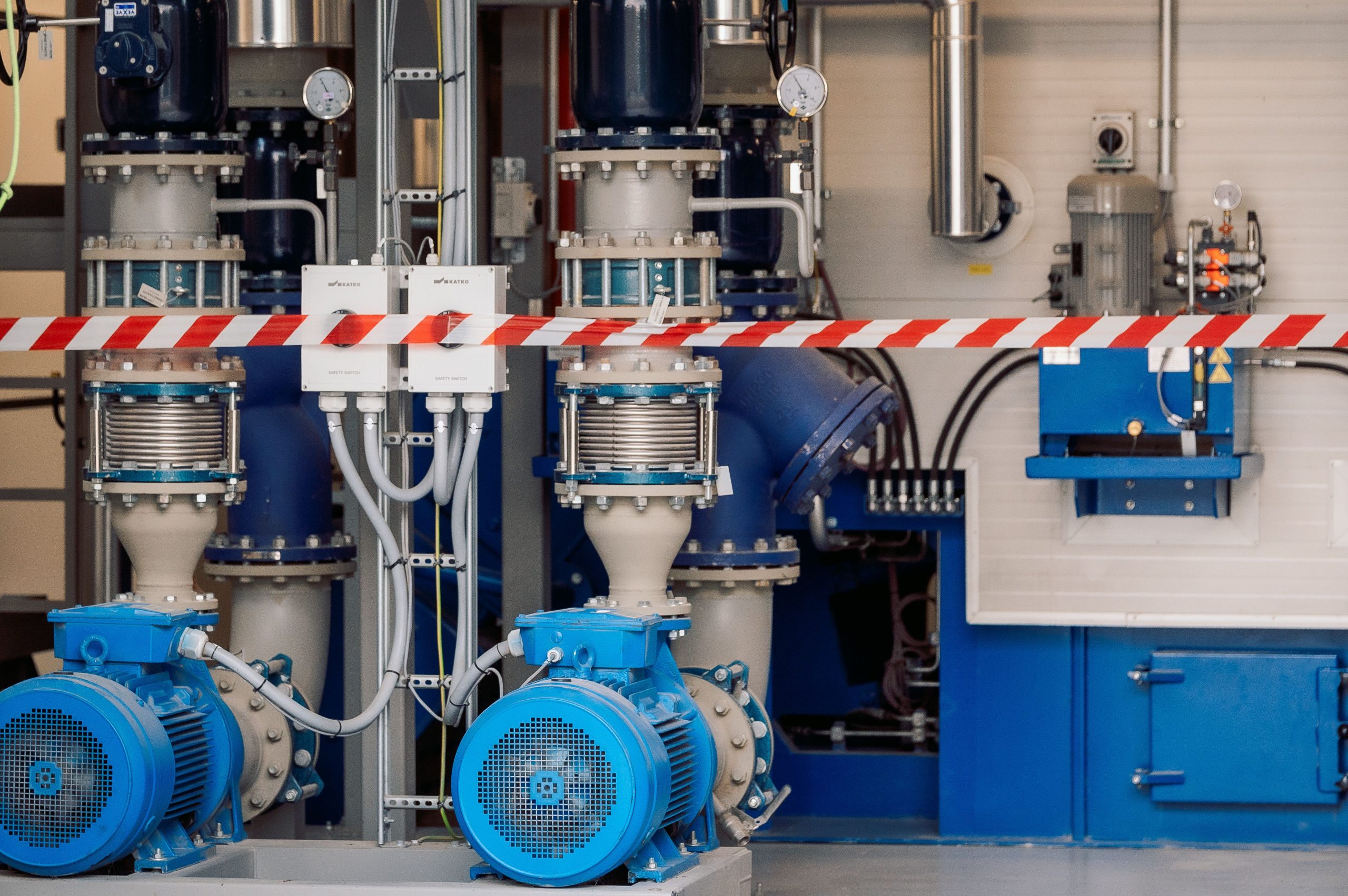 Blue industrial pumps and pipes